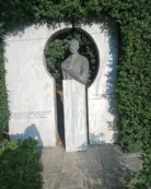 Statue by bus stop with page link